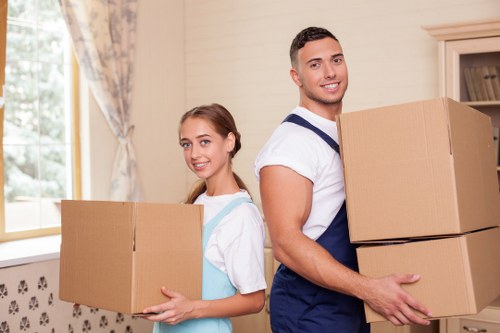 A family organizing boxes for secure storage in Newaddington